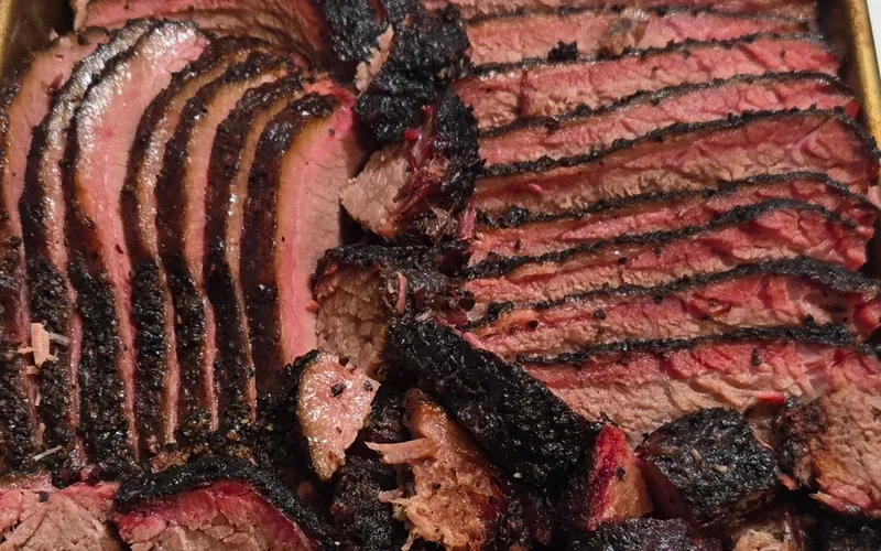 Sliced smoked brisket with a deep smoke ring