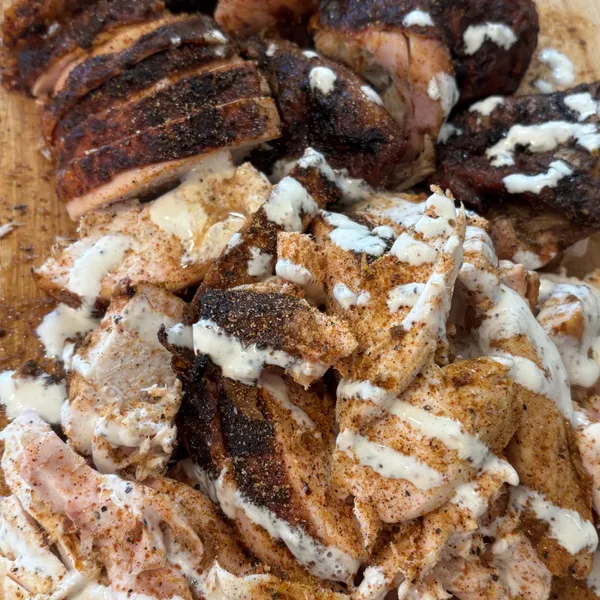 Shredded smoked chicken drizzled with a creamy white sauce
