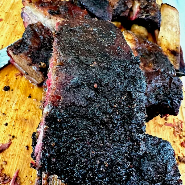 A whole brisket wrapped in butcher paper, ready to rest