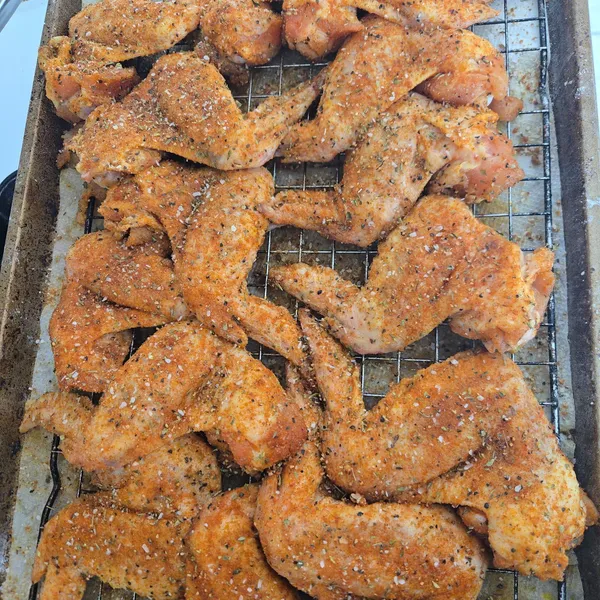 A tray of chicken wings, seasoned and ready for the smoker