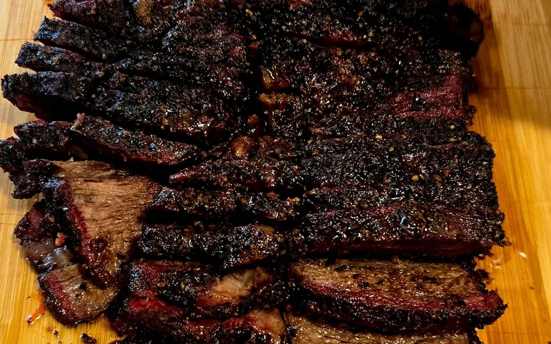 A whole smoked chicken, halved