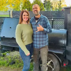 The Vanderwolf Smoke BBQ owners in front of their smoker trailer